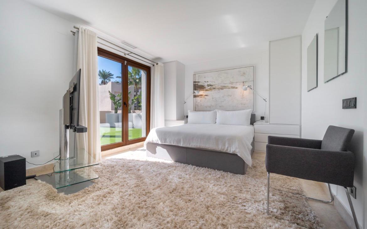 Master bedroom with king bed, art and garden access