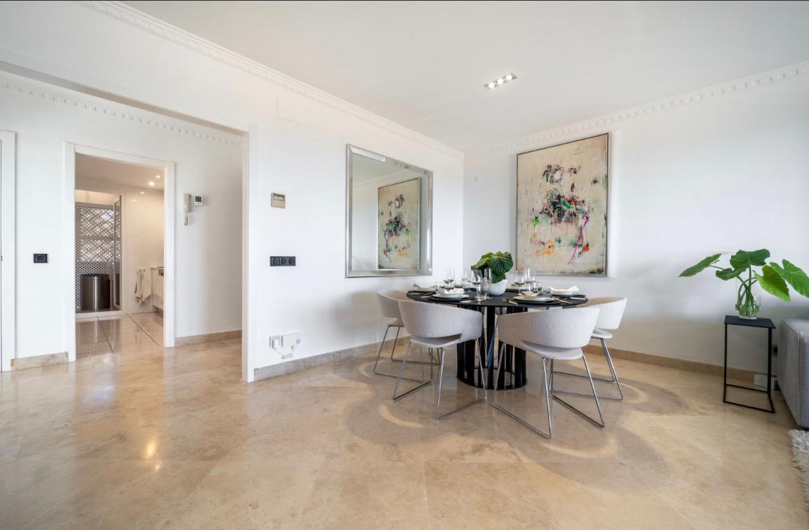 Bright living and dining room with travertine floors